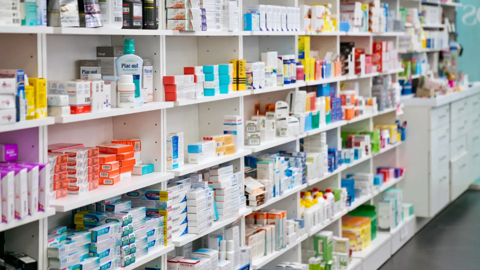 Well-stocked pharmacy shelves filled with medications and over-the-counter health products